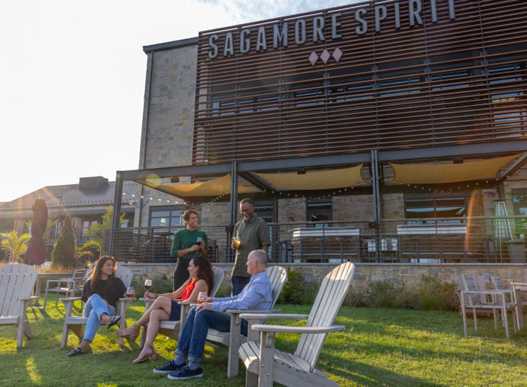 People lounging outside the Sagamore Sprit