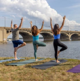 People doing Yoga overlooking the baltimore water front